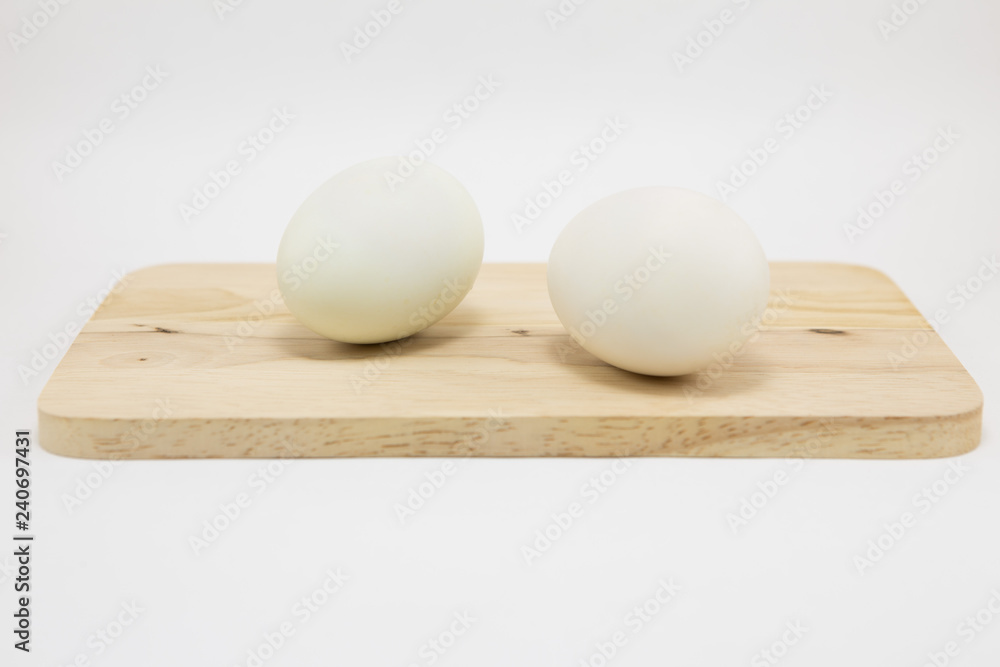 Fresh white eggs on a wooden cutting board Fresh white eggs on a wooden cutting board