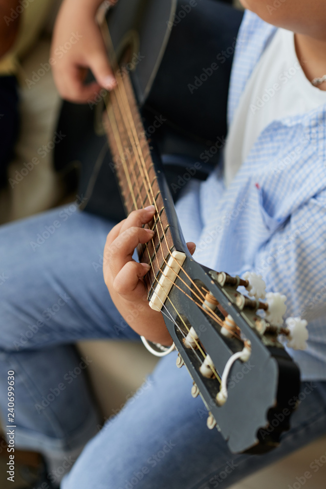 Close-up image of man playing guitar and singing songs Close-up image of man playing guitar and singing songs