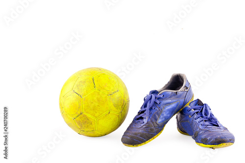 old vintage damaged futsal sports shoes and ragged yellow ball on white background football  object isolated