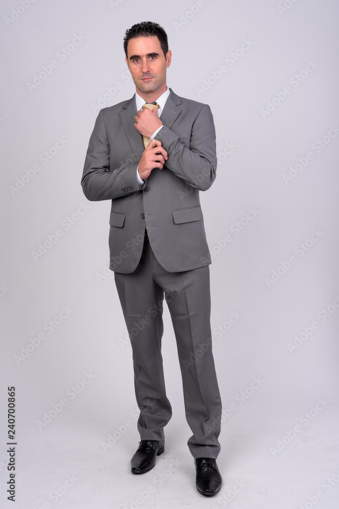 Full body shot of handsome businessman wearing suit Full body shot of handsome businessman wearing suit