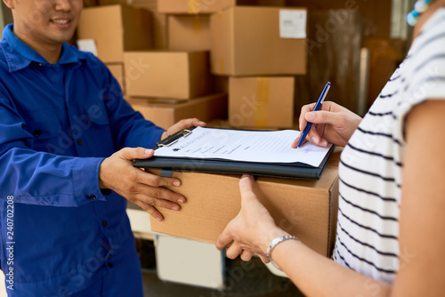 Woman signing document when receiving her package