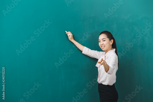 Asian teacher chalk and poses for photograph.. © Bangkok Click Studio