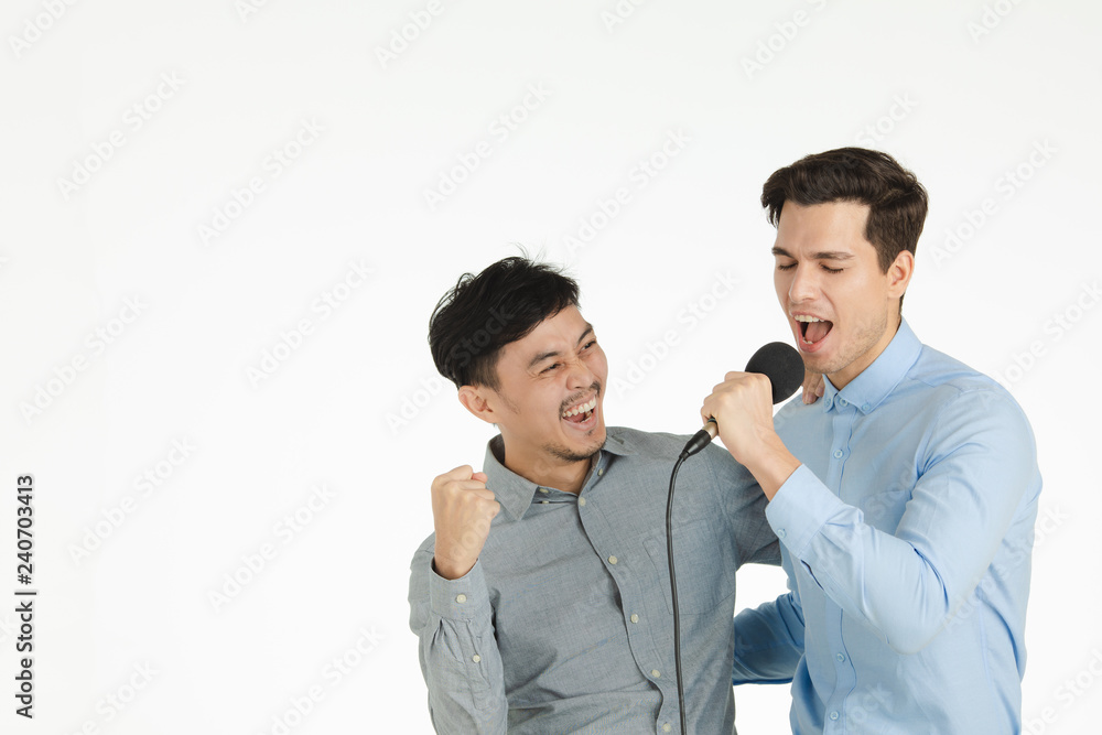two men singing karaoke pose
