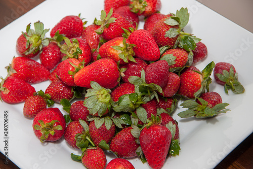 A plate of freshly picked strawberries for a healthy snack