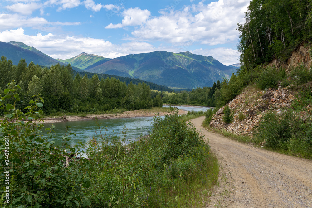 A dirt road runs along the Morkill River in British Columbia, Canada
