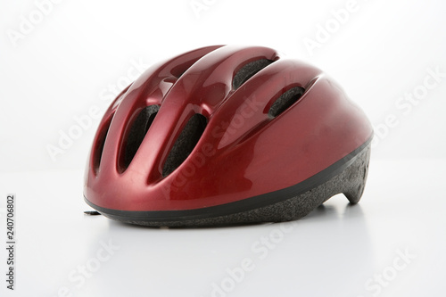 a red bicycle helmet on a white background