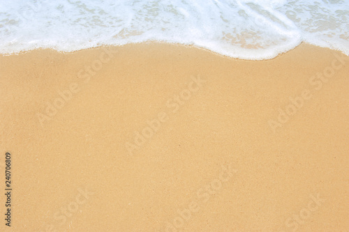 Soft ocean wave on clean sandy beach