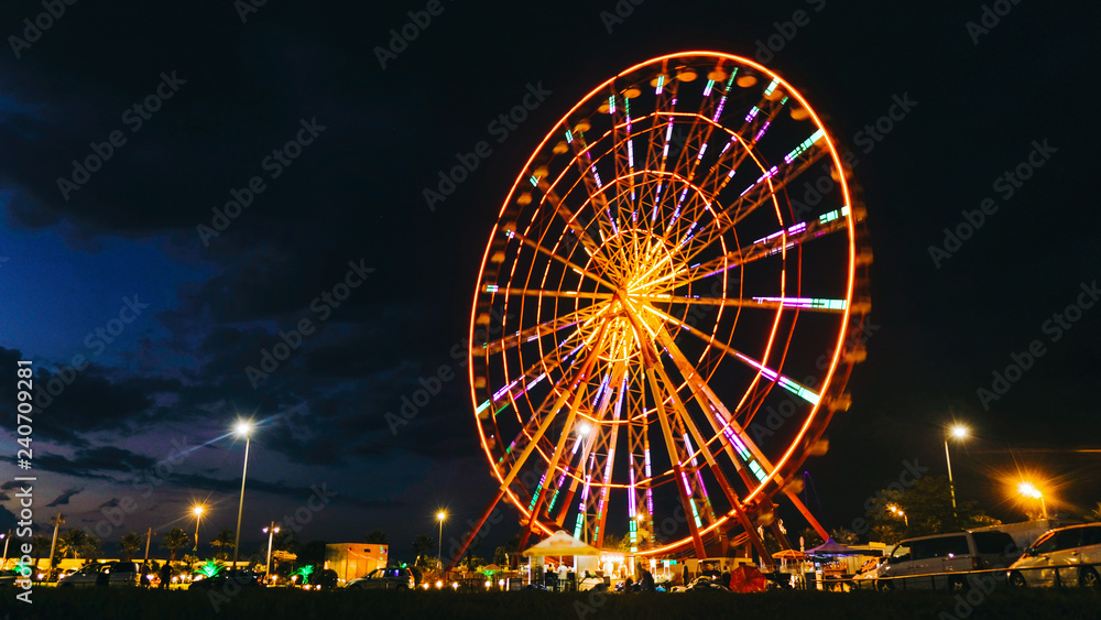 Time lapse ferris wheel on a sunset background on the sea