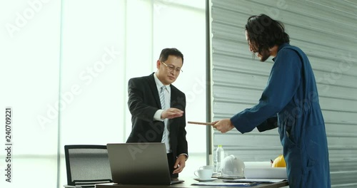 Young architect present sampling of tiles to executive architect, the senior groping on tile, concept for Young architect present his job in modern office.