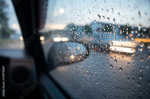 Rain drop on the window with light trail. Gloomy day