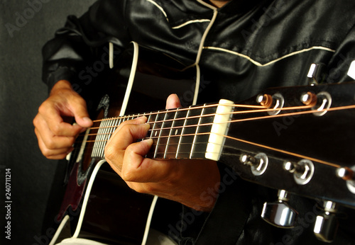 Guitarist plays the guitar. Close-up