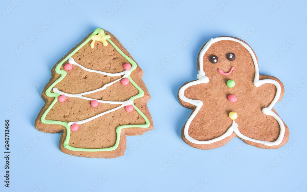 Gingerbread with Christmas tree isolated on light blue pastel background Gingerbread with Christmas tree isolated on light blue pastel background