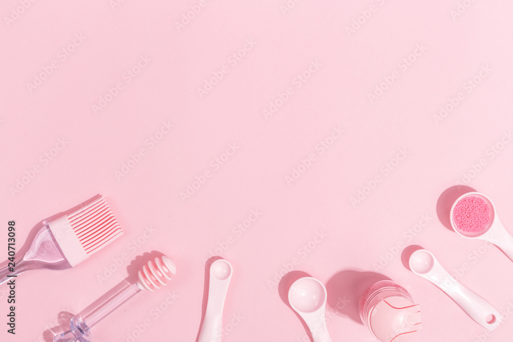 Kitchenware and toolson a pink background