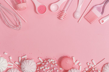 Kitchenware and tools, pastry and sweets on a pink background. Top view. Copy space.