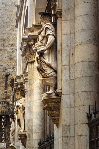Statues decorating facade of Loggia della mercanzia in Siena. Italy photo