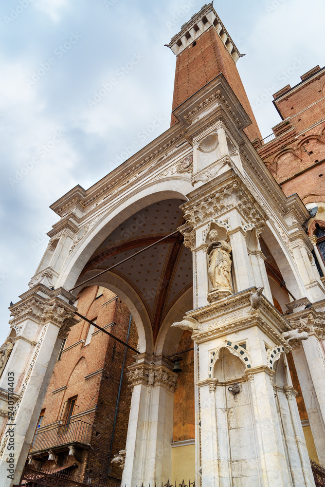 Cappella di Piazza and Torre del Mangia on Piazza del Campo, square and historic center in Siena. Italy