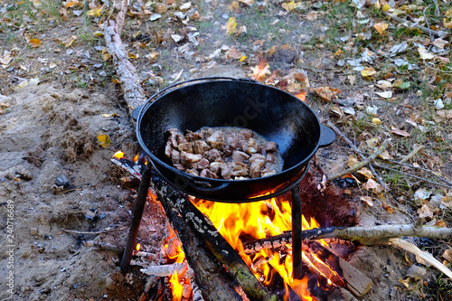meat in a cauldron on fire