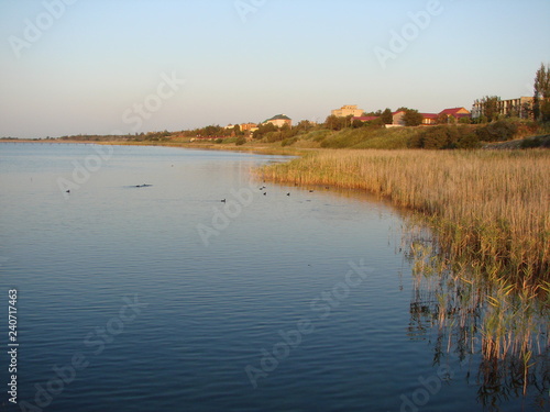 The tourist s view of the instant change of colors of the seaside nature at sunset.