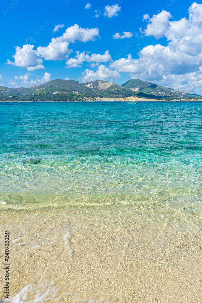Greece, Zakynthos, Speed boat cruising on perfect azure blue waters at coast of mountainous zante island
