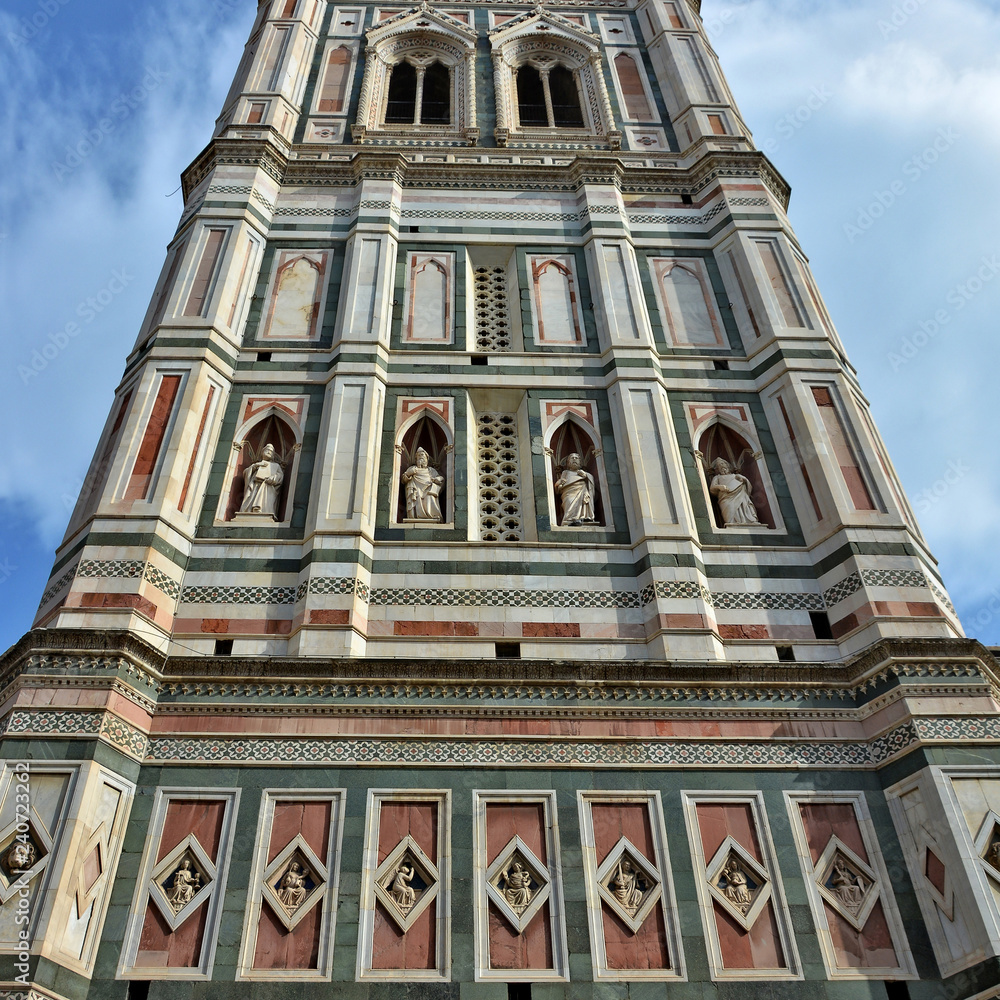 Giotto's Campanile stands adjacent to the Florence Cathedral. It is 84.7 meters tall. The tower has rich sculptural decorations & polychrome marble encrustations. Gothic architecture. Italy, Florence. Giotto's Campanile stands adjacent to the Florence Cathedral. It is 84.7 meters tall. The tower has rich sculptural decorations & polychrome marble encrustations. Gothic architecture. Italy, Florence.