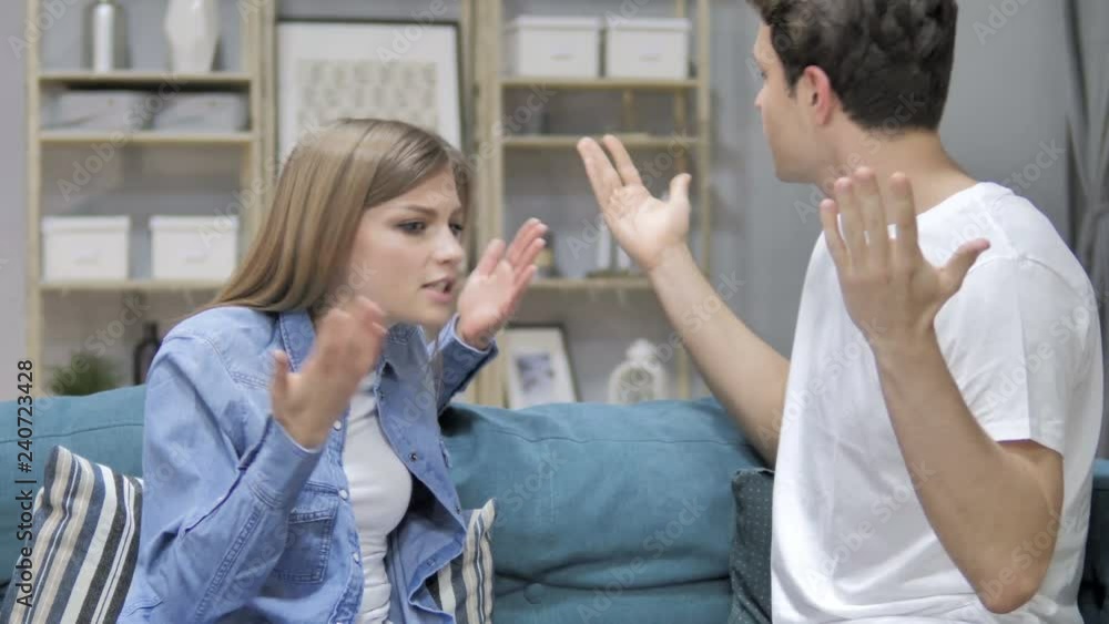 Angry Young Couple Yelling on Eachother During Argument at Home Angry Young Couple Yelling on Eachother During Argument at Home