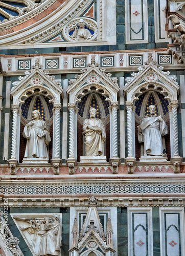 Italian Renaissance. Duomo Florence Cathedral (Santa Maria del Fiore). Architectural details of awesome marble facade with sculptures, mosaic ornament, carving. Italy, Florence
