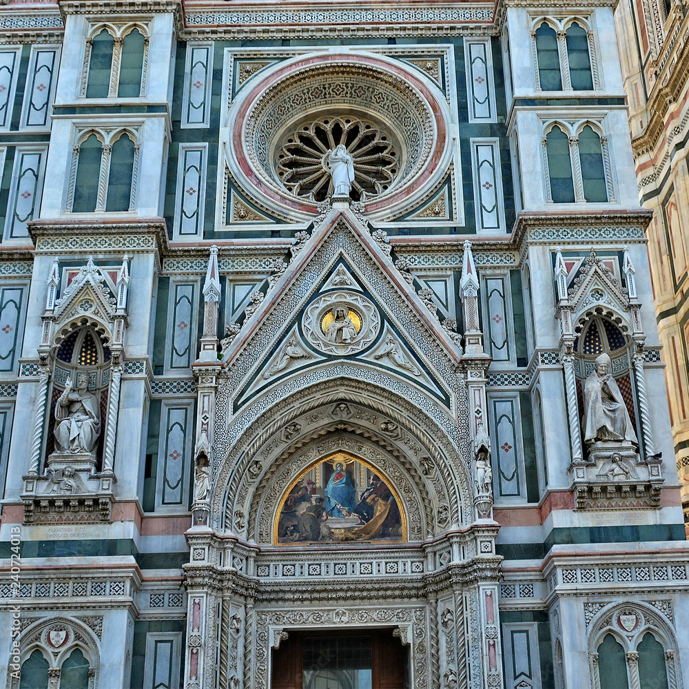 Duomo Florence Cathedral is the third largest church in the world. Italian Renaissance. Architectural details of awesome marble facade with sculptures, painting, rosettes. Italy, Florence