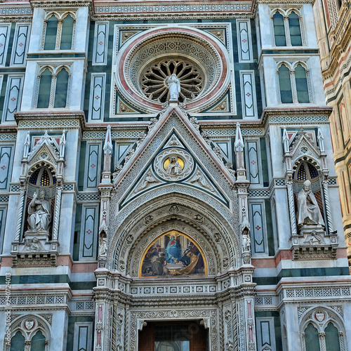 Duomo Florence Cathedral is the third largest church in the world. Italian Renaissance. Architectural details of awesome marble facade with sculptures, painting, rosettes. Italy, Florence