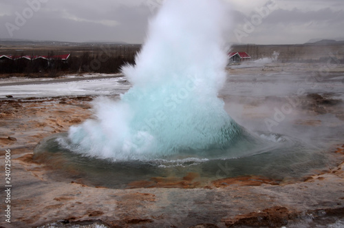 The eruption of the Strokkur geyser in the southwestern part of Iceland in a geothermal area near the river Hvitau
