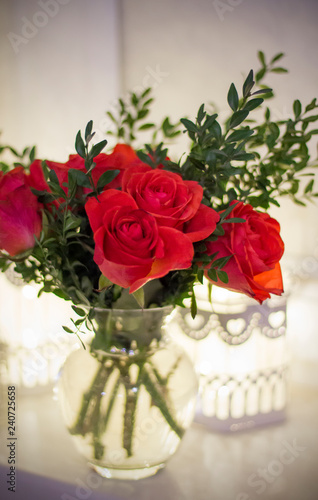 Wallpaper Mural A bouquet of red roses and boxwood in a vase with cells Torontodigital.ca