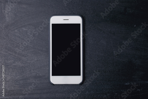 Smartphone with screen on the black jeans background.
