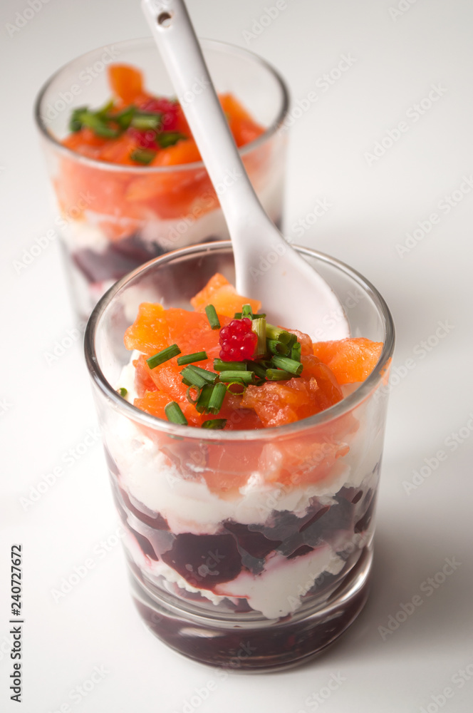 closeup of beet and salmon appetizers in little glasses on white background closeup of beet and salmon appetizers in little glasses on white background