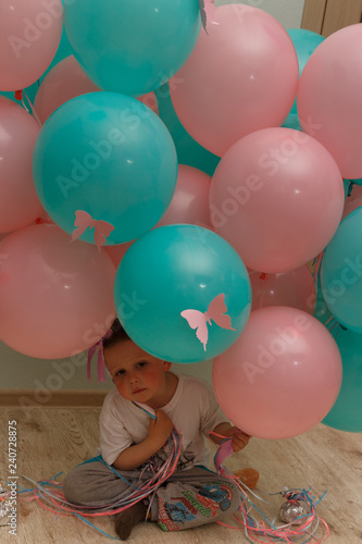 portrait, a sad boy with pink and blue balloons, with butterflies