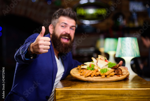 High calorie snack. Relax after hard day. Delicious food. Businessman formal suit sit at restaurant. Man received meal with fried potato fish sticks meat. He deserve delicious meal. Enjoy your meal