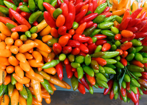 Small peppers are red, green and yellow.