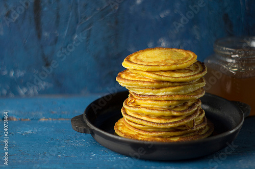 Frying pan of freshly baked pancakes, Ingredients and kitchenware for pancakes making.