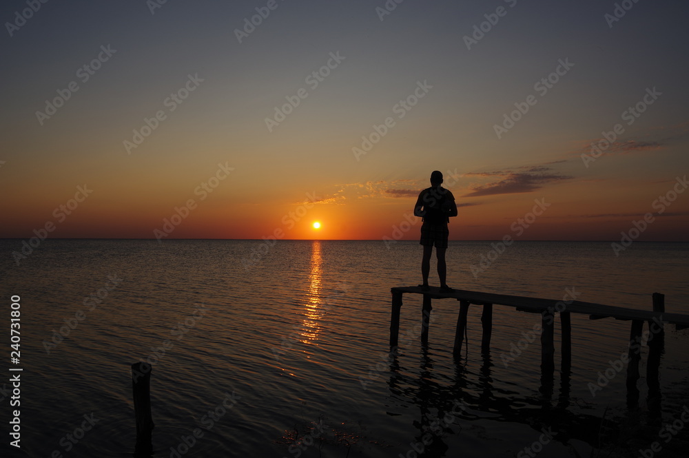 Sunset at the estuary with man