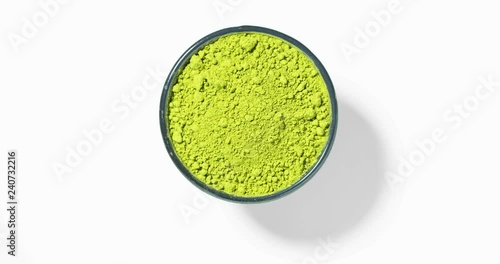 Matcha green tea in round bowl on white background, seamless loop, view directly from above.