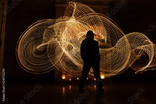 Human silhouette against backlight. Light painting photography.