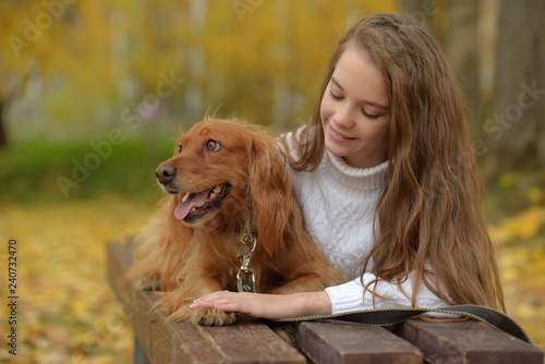 happy girl in the park with a spaniel