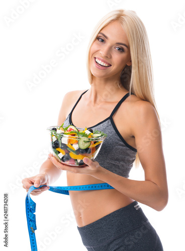 Woman in sportswear with tape measure and salad, isolated