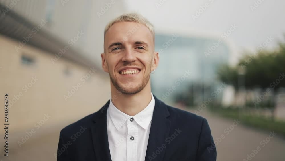 Portrait of young man with coffee looking into the camera. Laughing cheerful portrait of successful business man executive professional Portrait of young man with coffee looking into the camera. Laughing cheerful portrait of successful business man executive professional