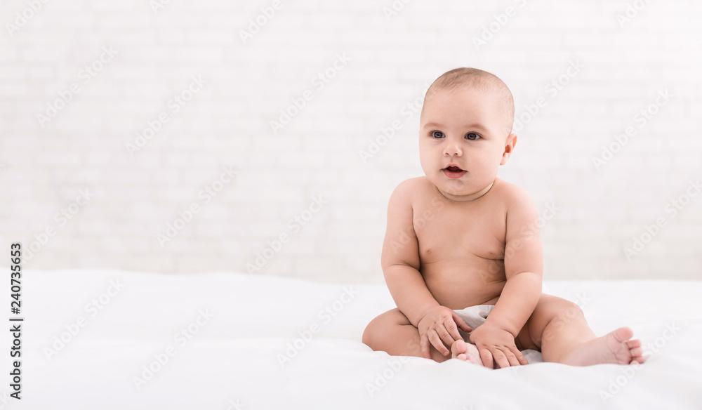 Cute baby sitting on white background, copy space Cute baby sitting on white background, copy space