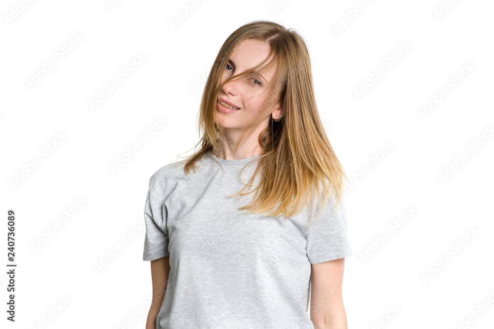 Portrait of a young happy woman who is waving her head and long hair isolated on a white background. Portrait of a young happy woman who is waving her head and long hair isolated on a white background.
