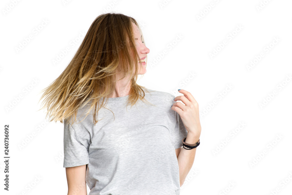 Portrait of a young happy woman who is waving her head and long hair isolated on a white background. Portrait of a young happy woman who is waving her head and long hair isolated on a white background.