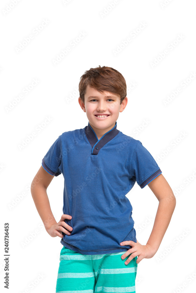 Full length portrait of cute little kid boy in stylish clothes looking at camera and smiling, standing against white studio wall. Kids fashion concept Full length portrait of cute little kid boy in stylish clothes looking at camera and smiling, standing against white studio wall. Kids fashion concept