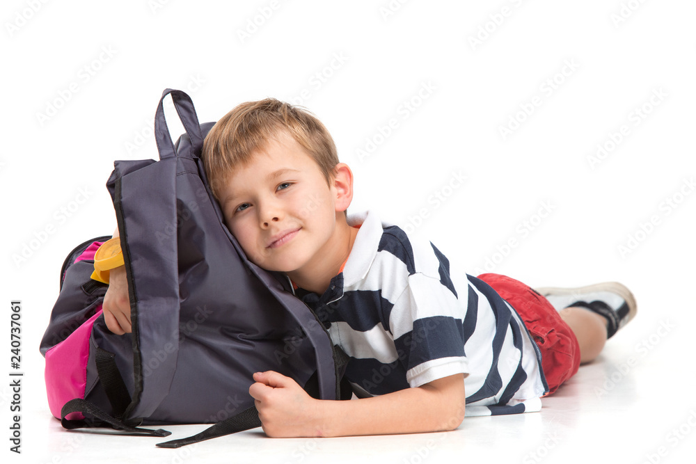 Full length portrait of cute little kid boy in stylish clothes looking at camera and smiling, standing against white studio wall. Kids fashion concept Full length portrait of cute little kid boy in stylish clothes looking at camera and smiling, standing against white studio wall. Kids fashion concept