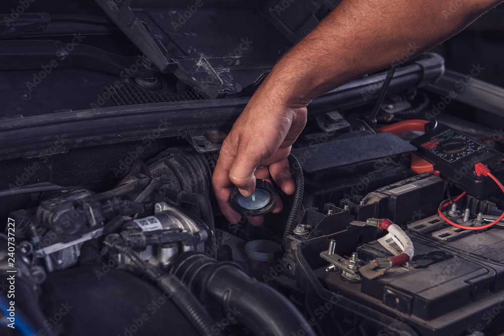 Car service worker diagnoses car breakdown. Car service worker diagnoses car breakdown.