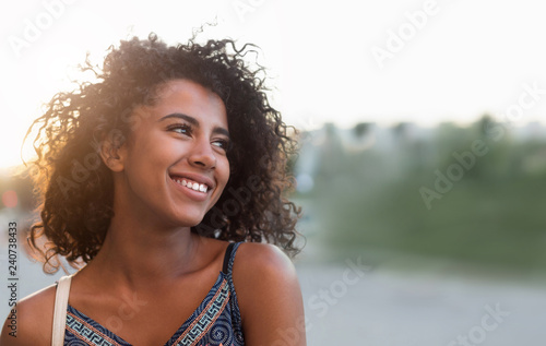 Outdoor portrait of smiling african american girl photo