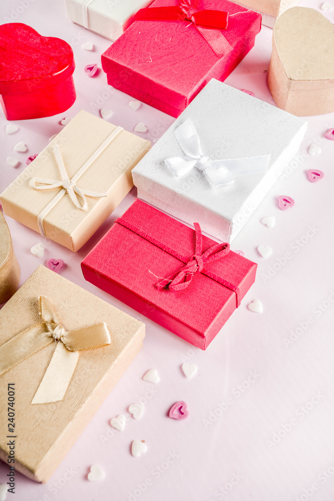 Valentines day gifts boxes background, frame for holiday greeting card background, with confetti candy hearts, flat lay, top view, copy space Valentines day gifts boxes background, frame for holiday greeting card background, with confetti candy hearts, flat lay, top view, copy space